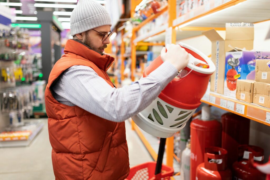 the buyer in the store chooses a gas cylinder for propane